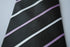 black tie with  thin purple and white stripes